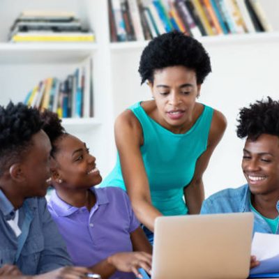 African american female teacher with students at university